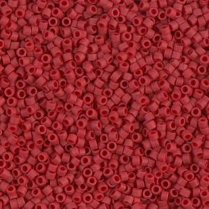 Close-up of tiny red beads with central holes.