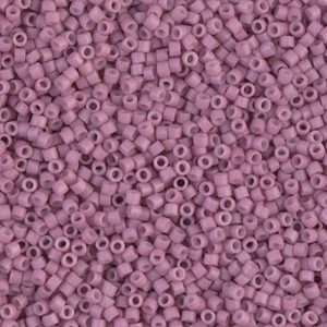 Close-up of numerous small, purple cylindrical beads with holes.