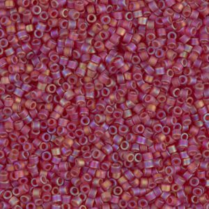 Close-up of tiny pinkish-purple beads scattered randomly.