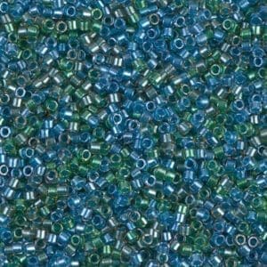 Close-up of small, translucent blue and green beads scattered together.