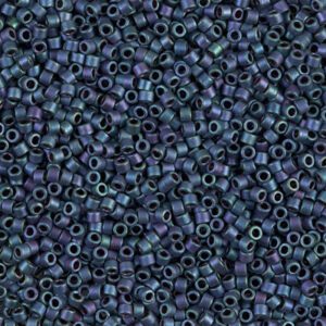 Close-up of tiny dark blue cylindrical beads with a subtle iridescent sheen.