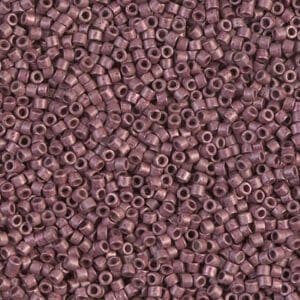 Close-up of small, round, purple beads with central holes.