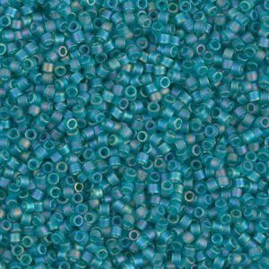 Close-up of small turquoise seed beads scattered densely.