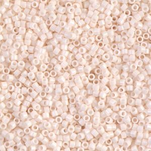 Close-up of small beige seed beads scattered densely.