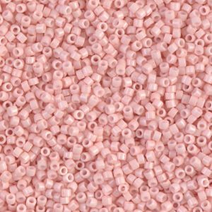 Close-up of small pink beads with holes in the center.