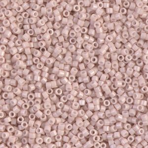 Close-up of small, pale pink seed beads scattered densely.