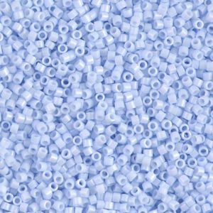 Close-up of numerous small, light blue plastic beads with holes in the center.