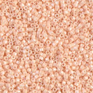 Close-up of small peach-colored seed beads scattered densely.