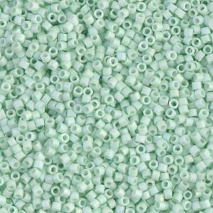 Close-up of small, light green seed beads.
