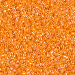 Close-up of small orange transparent beads scattered densely.
