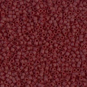 Close-up of small, round maroon beads with a matte finish.