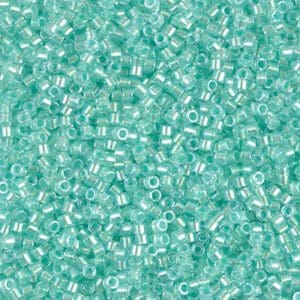 Close-up of numerous small, transparent turquoise beads.
