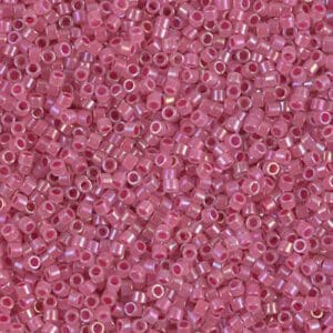 Close-up of small pink seed beads with a glossy finish.