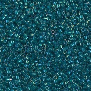 Close-up of shiny teal seed beads densely packed together.