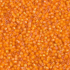 Close-up of small orange beads with translucent surfaces.