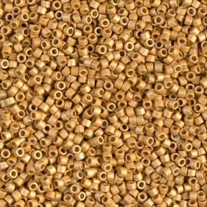 Close-up of numerous small, gold-colored beads with holes.