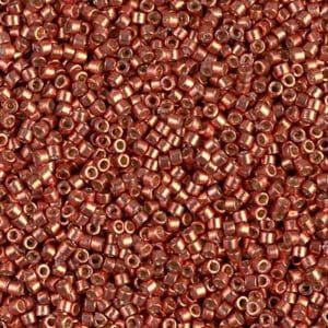 Close-up of small, shiny copper beads scattered densely.