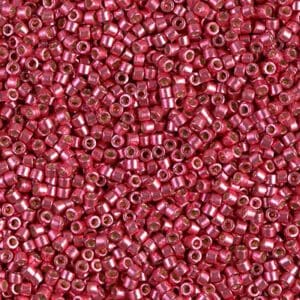 Shimmery raspberry glass seed beads, close detail