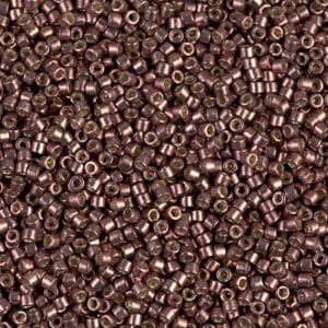 Close-up of small brown cylindrical beads scattered uniformly.