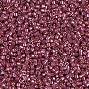 Close-up of numerous small purple seed beads.