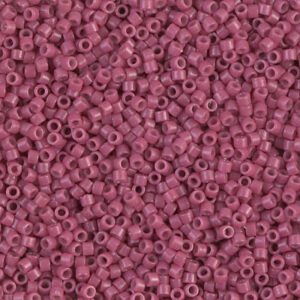 Close-up of small, pink cylindrical beads with hollow centers.