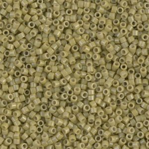 Close-up of small beige cylindrical beads scattered together.