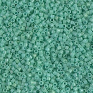 Close-up of small teal cylindrical beads densely packed together.