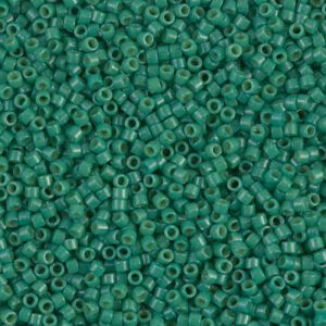 Close-up of small green seed beads scattered densely.
