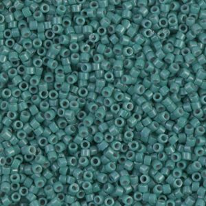 Close-up of small teal seed beads packed tightly together.
