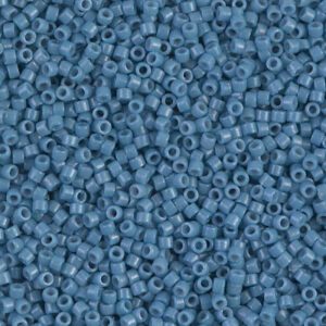Close-up of small blue seed beads densely packed together.