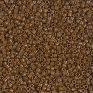 Close-up of small brown seed beads with holes in the center.