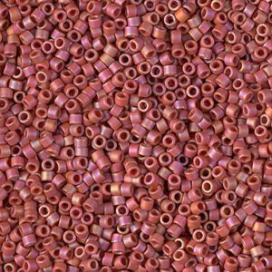 Close-up of small pink cylindrical beads with holes in the center.