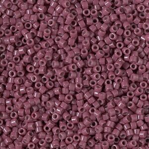 Close-up of tiny mauve-colored cylindrical beads densely packed together.