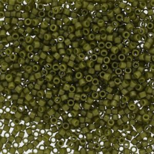Close-up of small, olive green seed beads scattered densely.