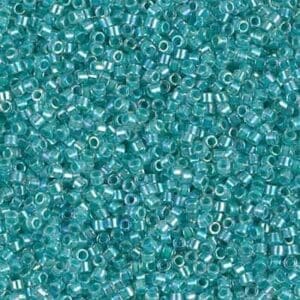 Close-up of small turquoise glass beads scattered together.
