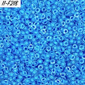 Close-up of numerous small blue glass beads with a glossy finish.