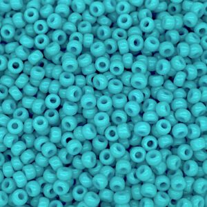 Close-up of small turquoise beads with holes.
