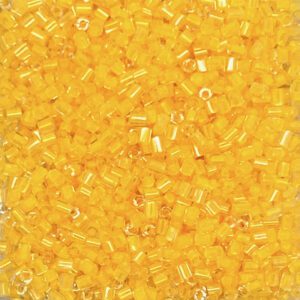 Yellow glass seed beads in close-up view.