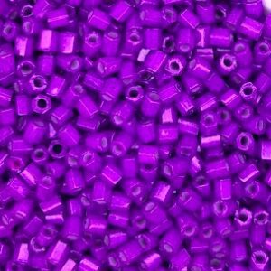 Purple cylindrical beads scattered in close-up.