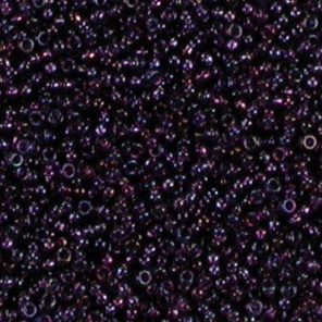 Dark purple seed beads scattered closely together.