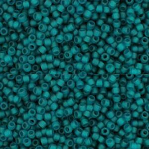 Teal seed beads scattered in close-up view.