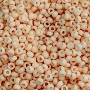 Beige wooden beads scattered in close-up.