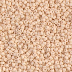 Beige seed beads scattered in close-up view.